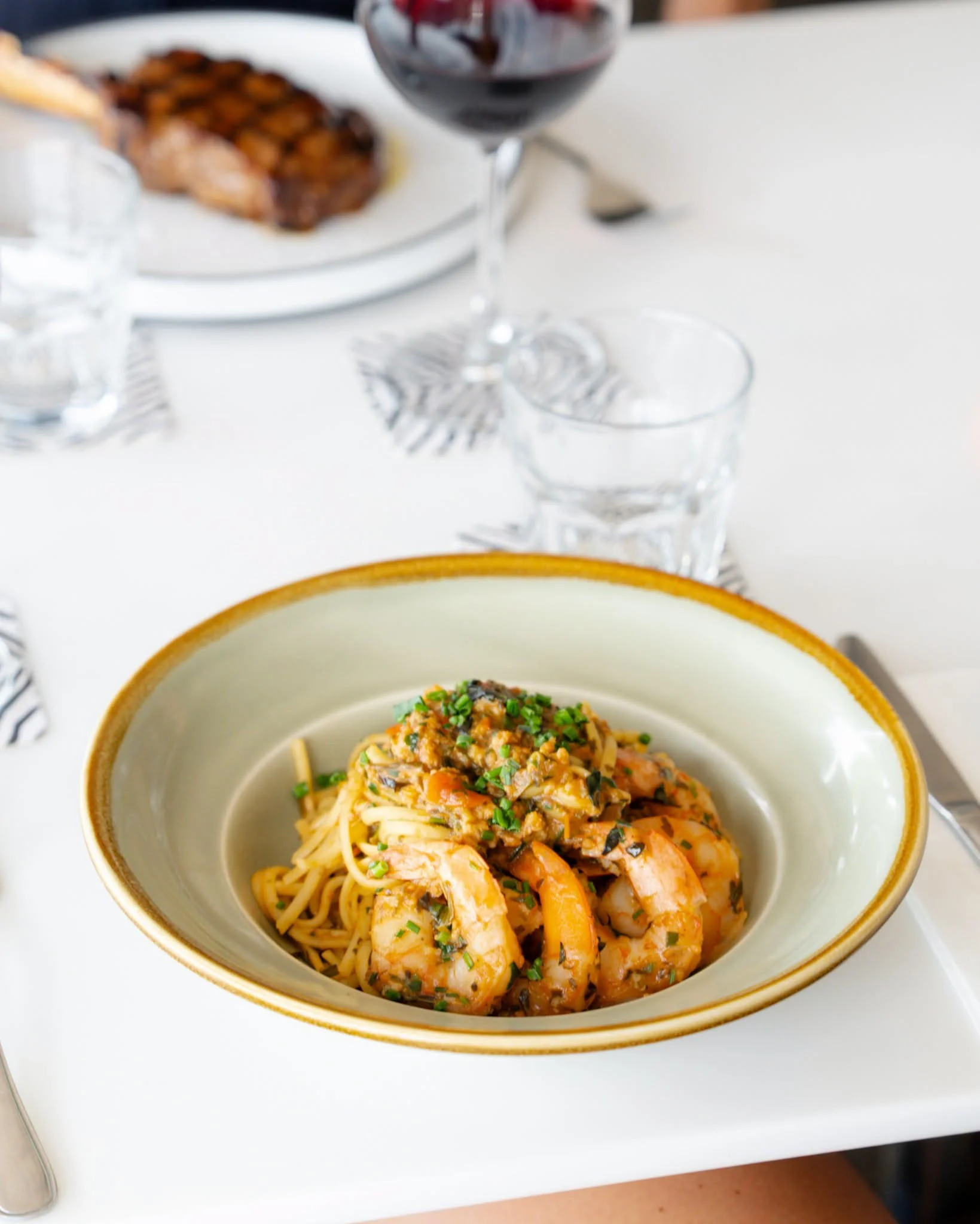 Prawn linguine with a glass of red wine at Waterbar & Grill Steakhouse, Cairns