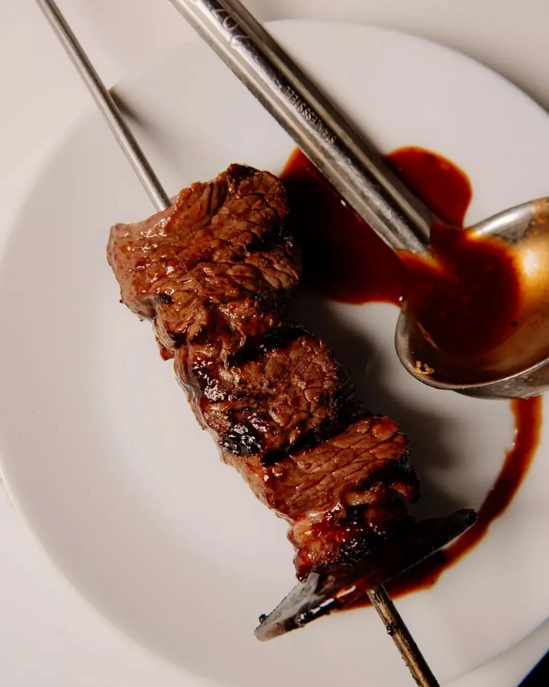 Chargrilled beef skewer glazed with jus at Waterbar & Grill Steakhouse, Cairns